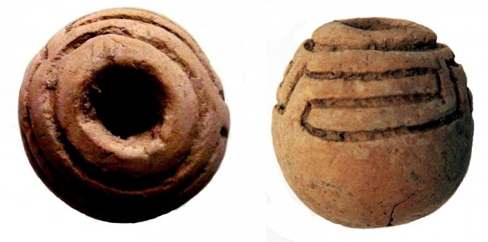 Globular to oval spindle whorl, decorated with incised meander; refined clay, Weaving House, Timpone della Motta, 8th c. BC, National Archaeological Museum, Sibari. Globular to oval spindle whorl, decorated with incised meander; refined clay, Weaving House, Timpone della Motta, 8th c. BC, National Archaeological Museum, Sibari.